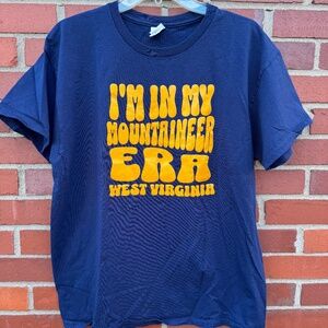 I'm in my Mountaineer Era West Virginia Univeristy blue gold WVU shirt- L